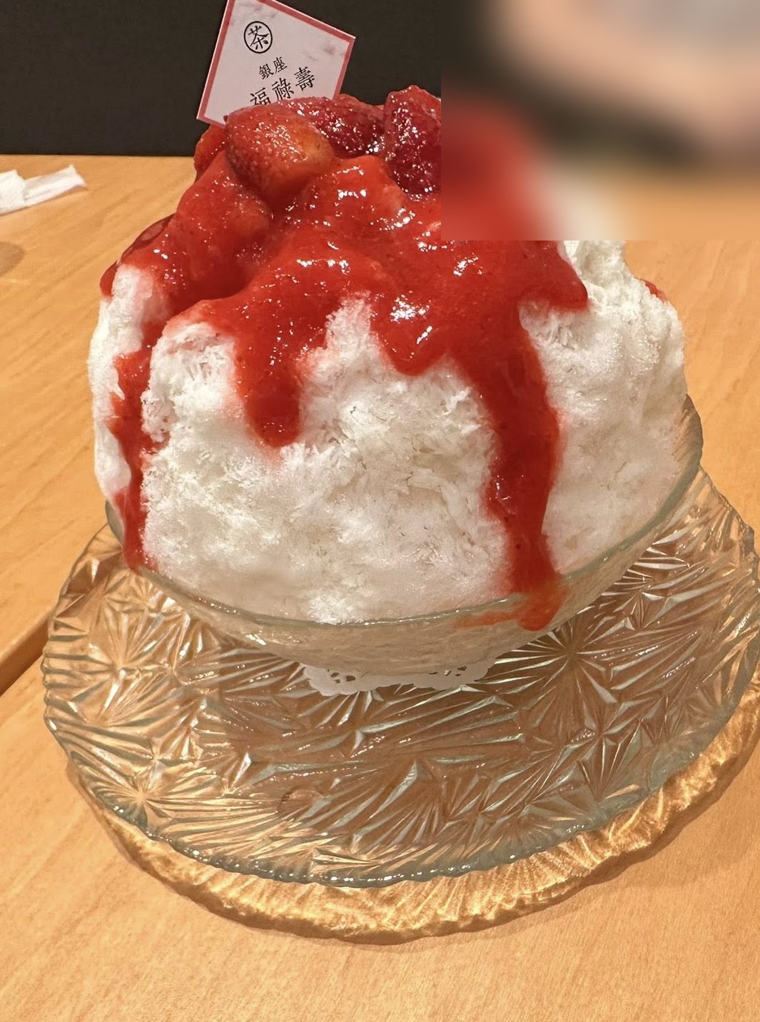Strawberry kakigori with fresh berries and strawberry sauce in a cut-glass bowl at Ginza Fukurokuju, Tokyo